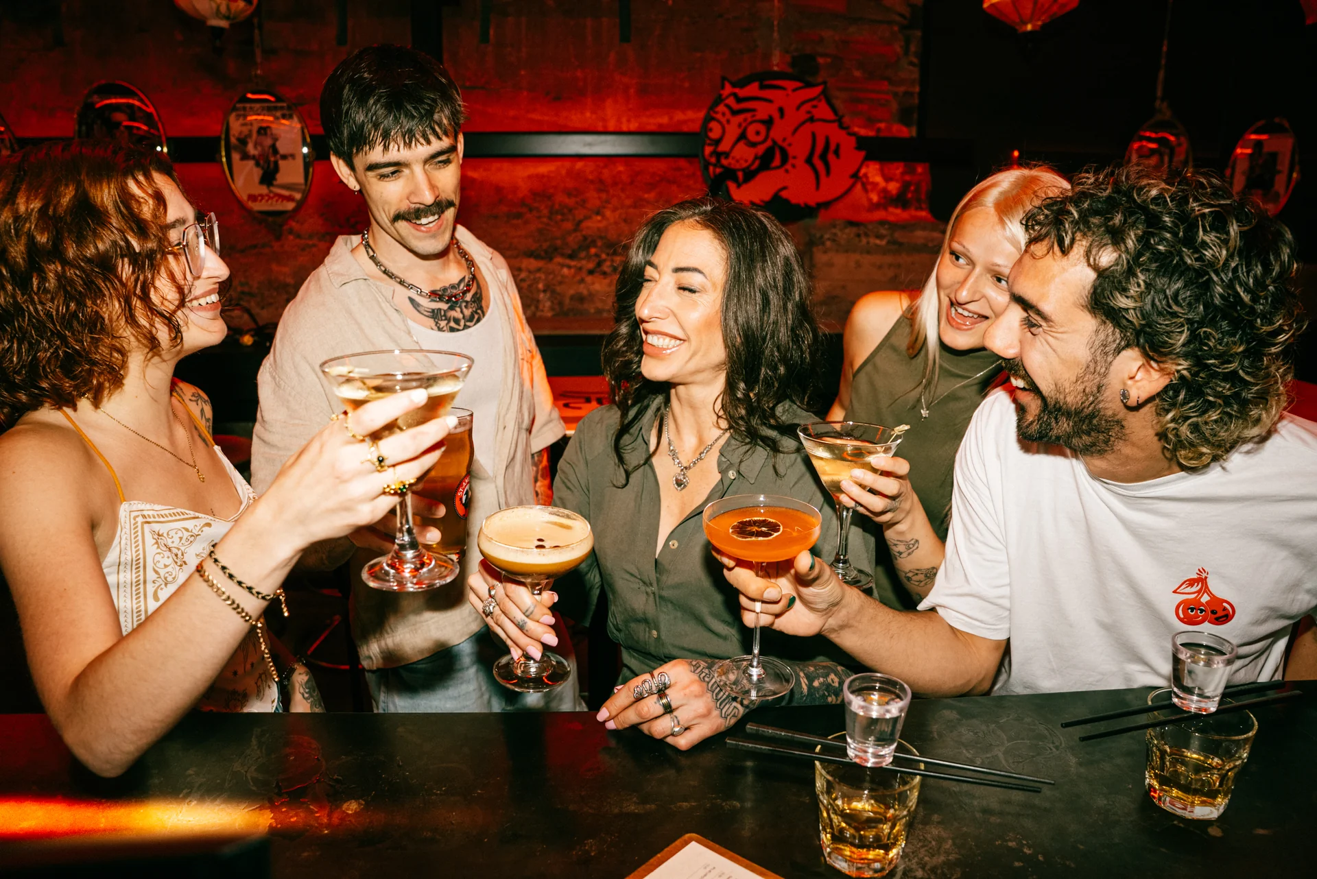 Un groupe d'amis au tiger bar avec un verre à la main